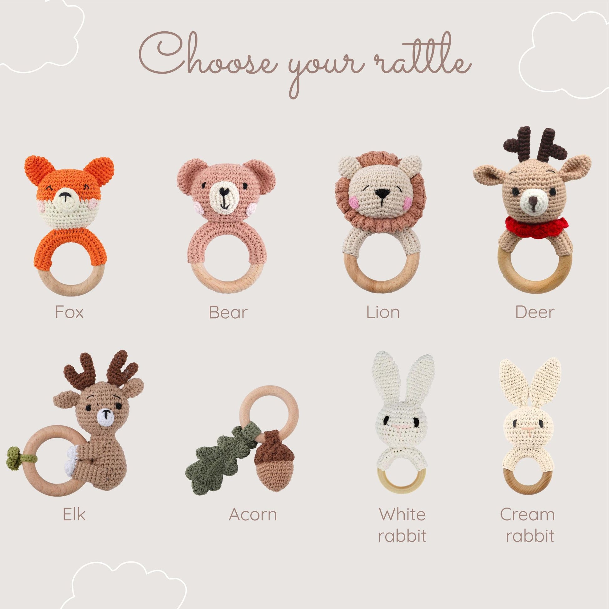 A selection of crocheted baby rattles displayed with the title "Choose your rattle." The rattles include:
A fox rattle with orange and white details.
A bear rattle in soft pink.
A lion rattle with a beige mane.
A deer rattle with antlers and a red scarf.
An elk rattle with antlers and a green leaf accent.
An acorn rattle with a wooden ring and green leaf detail.
A white rabbit rattle with long ears.
A cream rabbit rattle with long ears. The rattles are arranged on a neutral background with soft cloud accent